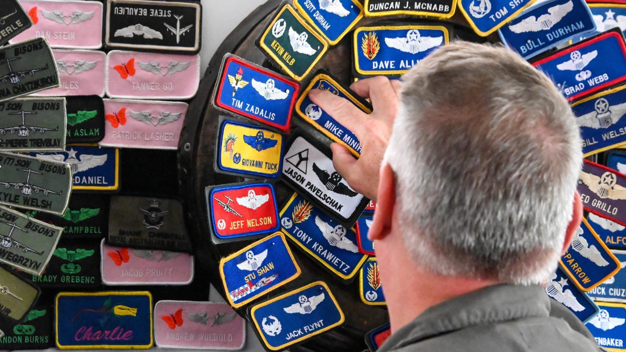 U.S. Air Force Gen. Mike Minihan, Air Mobility Command commander, places a nametag on the wall of a facility at Altus Air Force Base (AAFB), Oklahoma, Aug. 25, 2022. Aircrew members occasionally practice the tradition of adding their name tags to the walls of facilities they have visited. (U.S. Air Force photo by Senior Airman Kayla Christenson)