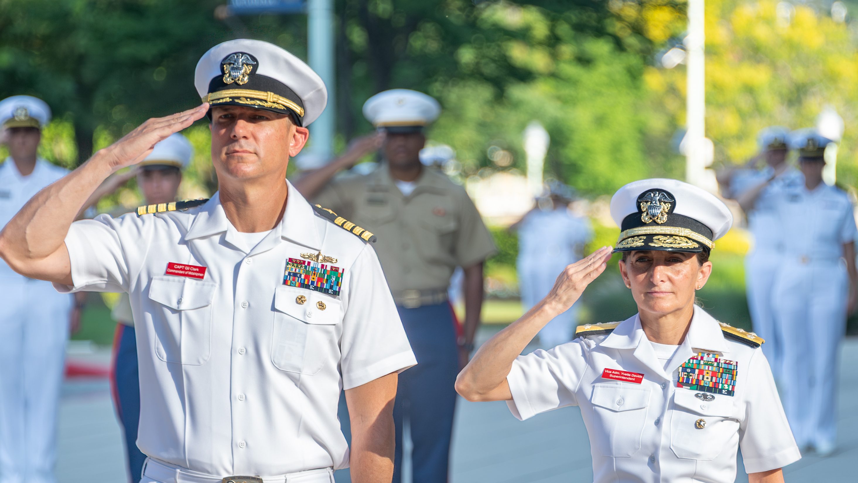 ANNAPOLIS, Md. (June 26, 2025) U.S. Naval Academy 65th Superintendent Vice Adm. Yvette Davids and Commandant of Midshipmen Capt. Gilbert Clark Jr. salute during morning colors during Induction Day at Alumni Hall. Midshipman candidates, or plebes, of the class of 2029 receive instruction from detailers during Induction Day which marks the beginning of a demanding six-week indoctrination period called Plebe Summer, intended to transition the candidates from civilian to military life. As the undergraduate college of our country’s naval service, the Naval Academy prepares young men and women to become professional officers of competence, character, and compassion in the U.S. Navy and Marine Corps. (U.S. Navy photo by Stacy Godfrey)