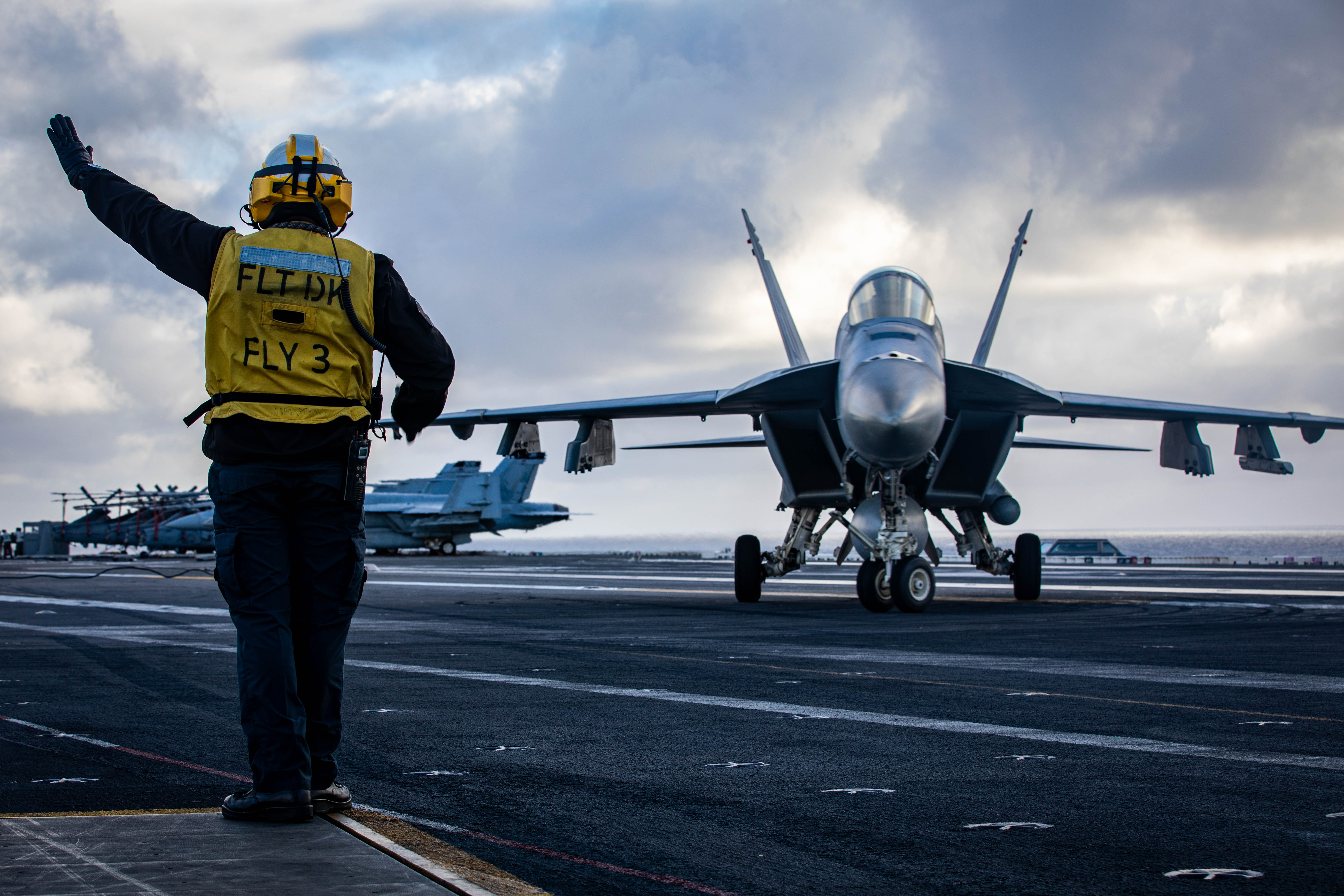 Aviation Boatswain’s Mate (Aircraft Handling) 1st Class Jose Mejiacastro, assigned to Air Department aboard the world's largest aircraft carrier, USS Gerald R. Ford (CVN 78), signals to a Carrier Air Wing 8 F/A-18E Super Hornet attached to Strike Fighter Squadron 87, Aug. 20, 2025. Gerald R. Ford, a first-in-class aircraft carrier and deployed flagship of Carrier Strike Group Twelve, is on a scheduled deployment in the U.S. 6th Fleet area of operations to support the warfighting effectiveness, lethality and readiness of U.S. Naval Forces Europe-Africa, and defend U.S., Allied and partner interests in the region. (U.S. Navy photo by Mass Communication Specialist 2nd Class Mariano Lopez)