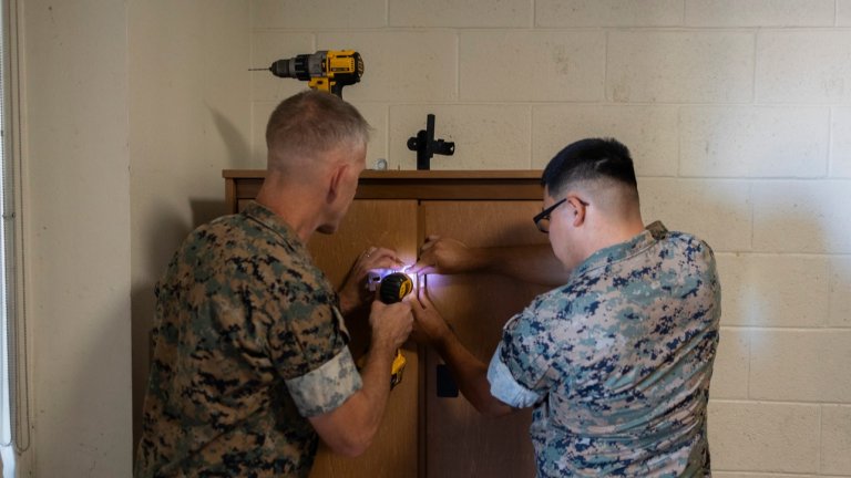 U.S. Marine Corps Lt. Gen. Christian F. Wortman, commanding general of I Marine Expeditionary Force, left, and Lance Cpl. Elijah Merino, a grenadier with 1st Marine Regiment, 1st Marine Division, repair a wall locker during Operation Clean Sweep III at Marine Corps Base Camp Pendleton, California, Sept. 16, 2025. OCS III, part of the ongoing Barracks 360 Reset initiative, demonstrates a collective commitment to improving living conditions through shared ownership, sustained accountability, and tangible improvements to the barracks. Wortman is a native of Pennsylvania and Merino is a native of California. (U.S. Marine Corps photo by Sgt. Bryant Rodriguez)