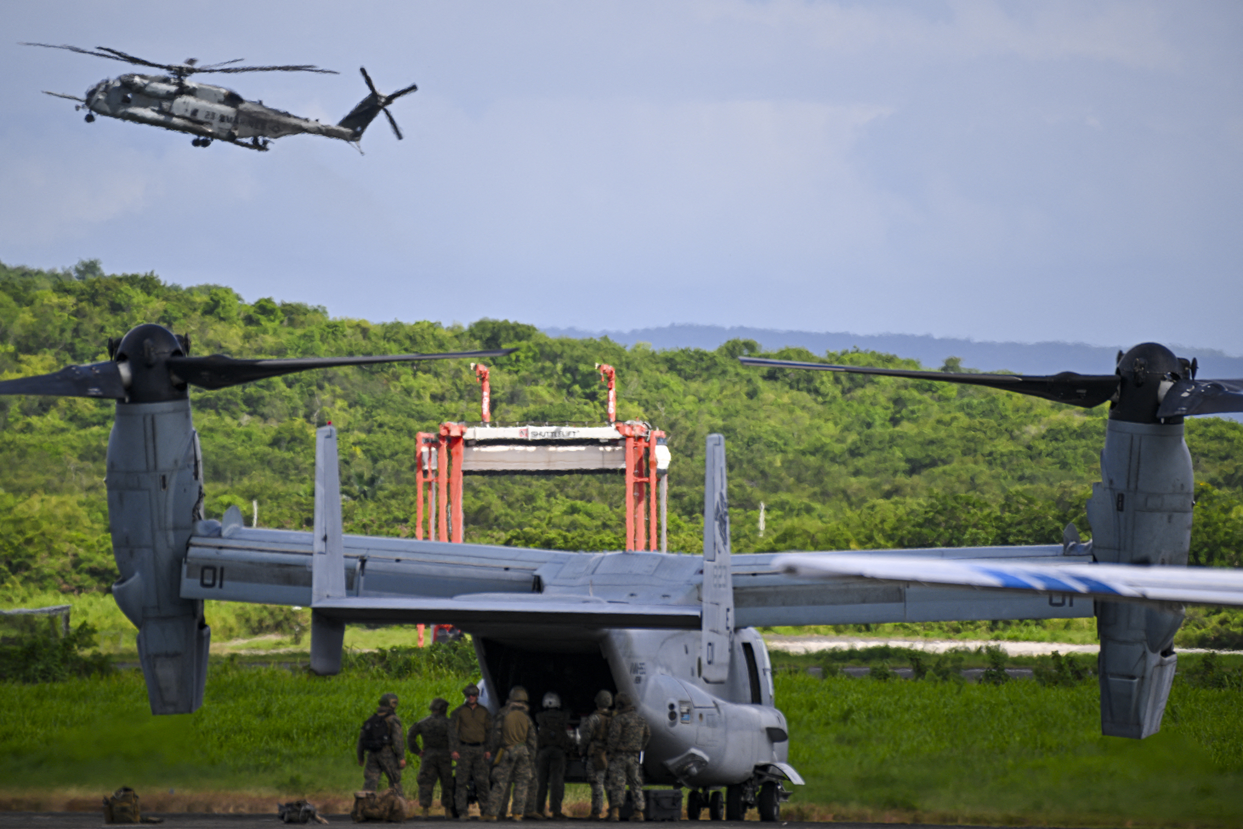 US Marines unload from an Osprey V-22 aircraft at Jose Aponte de la Torre Airport, formerly Roosevelt Roads Naval Station, on September 13, 2025, in Ceiba, Puerto Rico. President Donald Trump is sending ten F-35 fighter jets to Puerto Rico as part of his war on drug cartels, sources familiar with the matter told AFP on September 5, as tensions mount with Venezuela over Washington's military build-up in the Caribbean. (Photo by Miguel J. Rodriguez Carrillo / AFP) (Photo by MIGUEL J. RODRIGUEZ CARRILLO/AFP via Getty Images)