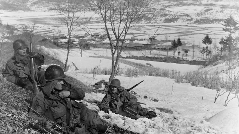 On a snow covered hillside, three members of a US machine gun squad lay exhausted after taking a Communist position. (Photo by © CORBIS/Corbis via Getty Images)
