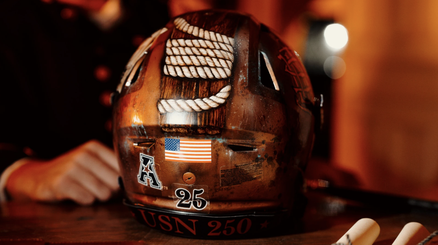 The custom, copper-painted helmet of the 2025 Navy football uniform includes the image of a rope with 63 knots on both the front and back, symbolizing the 126th Army-Navy game.