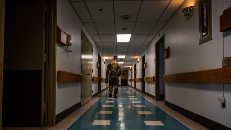 A New Jersey National Guard Soldier, 508th Military Police Company, walks down the hallway at East Orange General Hospital, East Orange, N.J., April 29, 2020. The National Guard is assisting the New Jersey Office of Emergency Management in reopening a wing of the East Orange General Hospital in response to the COVID-19 relief effort. (U.S. Army National Guard photo by Spc. Michael Schwenk)