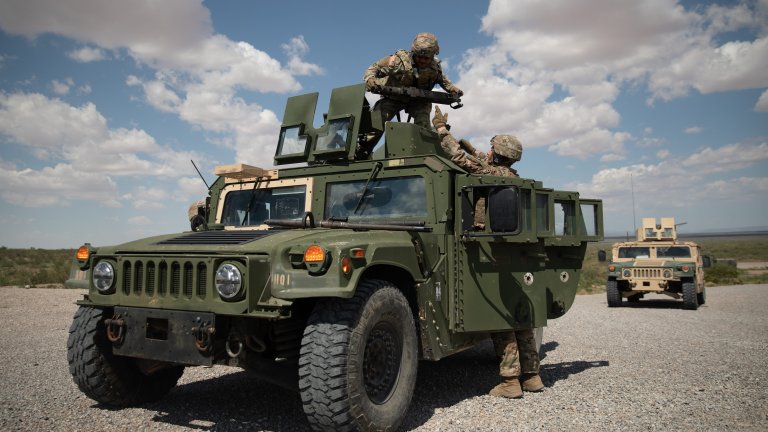 U.S. Army Pfc. Daniel Flores, left, and Spc. Evan Card, both with 101st Sustainment Brigade, assigned to Joint Task Force-Southern Border (JTF-SB), mount a M2A1 machine gun to their M1114 Humvee before a gunnery exercise at Dona Ana Training Complex, N.M., Aug. 21, 2025. Gunneries are a routine training exercise that Soldiers conduct in order to stay proficient in warrior tasks and drills. JTF-SB executes full-scale, agile, and all-domain operations in support of U.S. Customs and Border Protection to protect the territorial integrity of the United States and achieve 100% operational control of the southern border. (U.S. Army photo by Sgt. Elijah Ingram)
