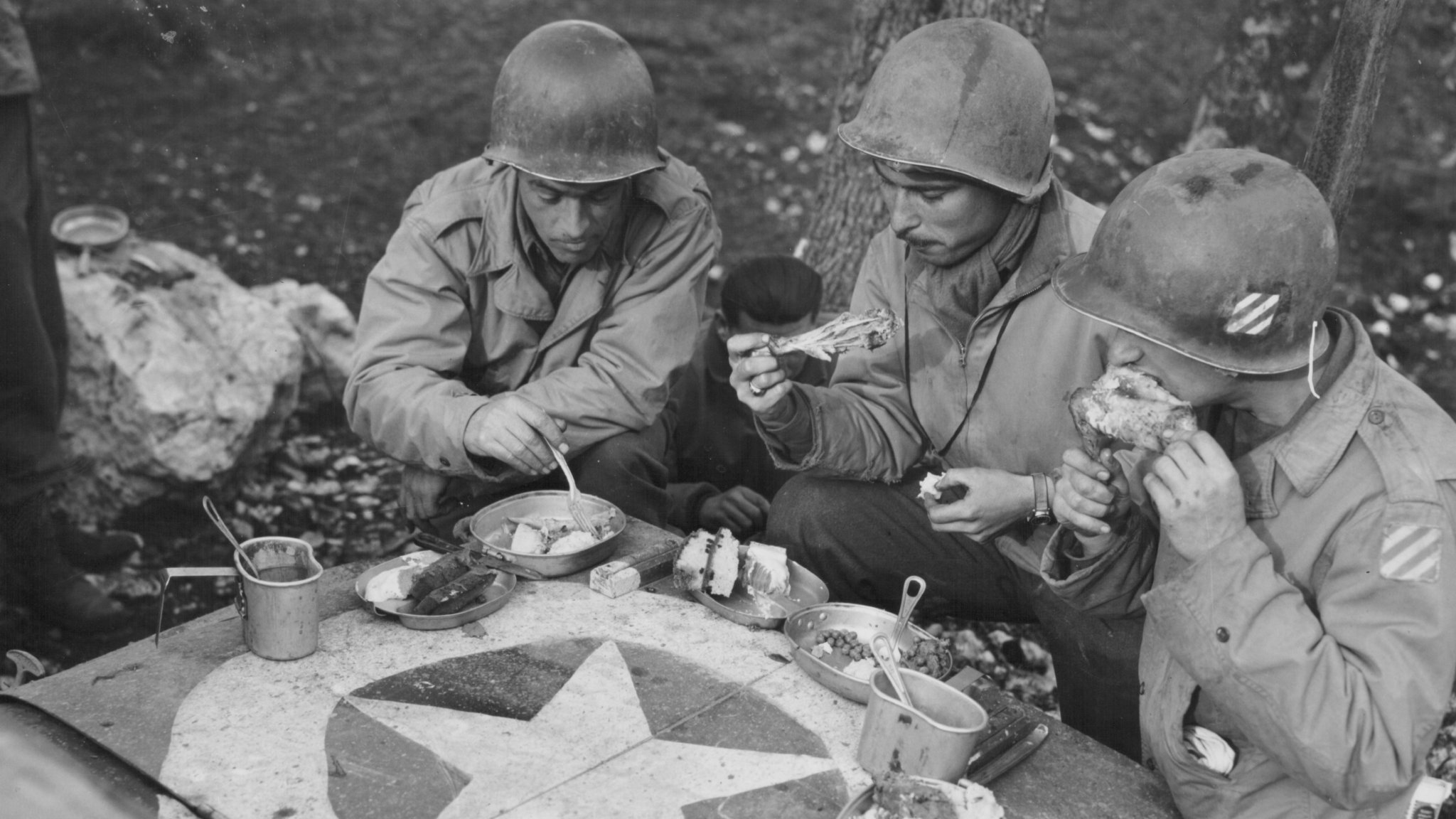 Image: Jeep: US soldiers of the 3rd Division having Christmas dinner on the hood of a jeep on the front lines, World War Two, France, December 25th 1943. (Photo by Archive Photos/Getty Images)