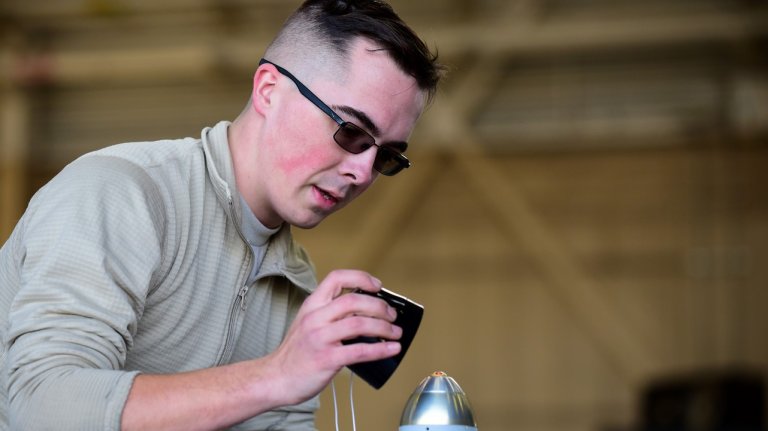 Airman 1st Class Charles Crumlett, 335th Aircraft Maintenance Unit weapons load crew member, prepares a weapon to be loaded during the 4th Quarter Load Crew of the Quarter competition, Jan. 26, 2018, at Seymour Johnson Air Force Base, North Carolina. The purpose of the weapons load competition is to showcase the weapons crews highly developed skills with precise loading capabilities. (U.S. Air Force photo by Airman 1st Class Kenneth Boyton)