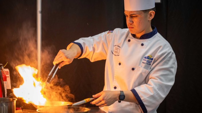 FORT GREGG-ADAMS, Va. – Culinary Specialist Seaman Alejandro Escobar competes in the Student Chef of the Year event as part of team U.S. Navy during the 49th Joint Culinary Training Exercise (JCTE) held at Fort Gregg-Adams, Virginia, March 5th, 2025. The JCTE is an annual event showcasing culinary talent across all components of the Department of Defense and is the largest American Culinary Federation-sanctioned competition in North America. (U.S. Navy photo by Brett Dodge)
