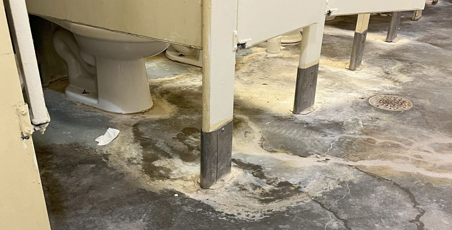 A photo taken by the Inspector General of the Doña Ana Range Complex's bathroom with sewage leaks.