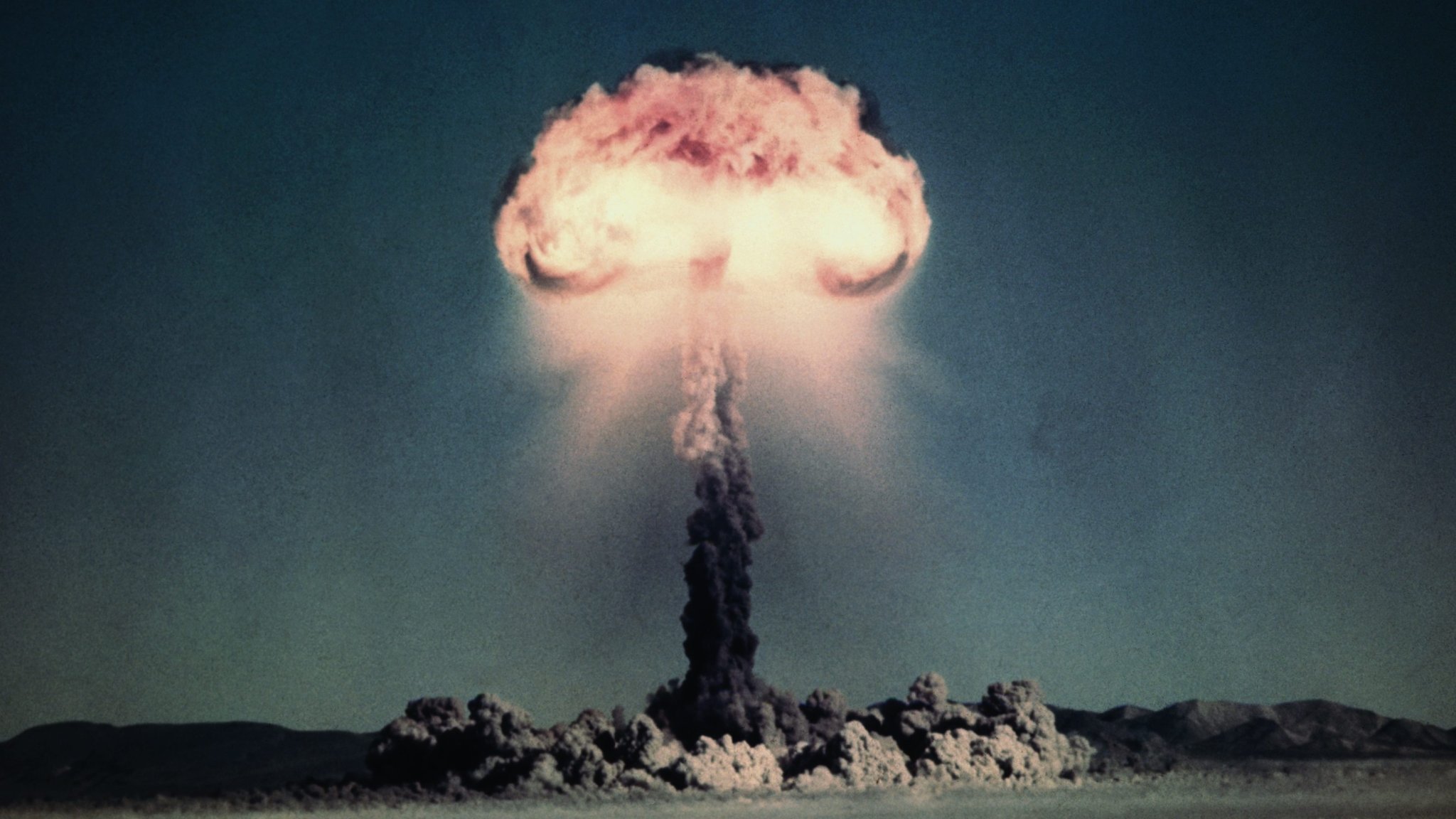 A mushroom cloud rises from a nuclear weapon test during Operation TUMBLER-SNAPPER. Over two thousand Marines witnessed the event, which was conducted in 1952 at the Nevada Proving Ground.