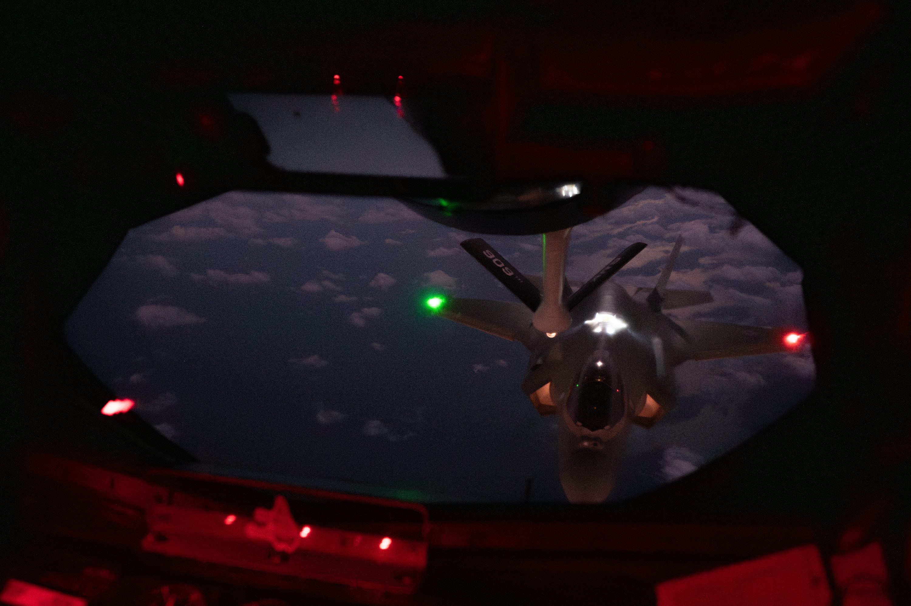 A U.S. Air Force F-35A Lightning II assigned to the 4th Expeditionary Fighter Squadron, deployed to Kadena Air Base, approaches a KC-135 Stratotanker assigned to the 909th Air Refueling Squadron for aerial refueling over the Pacific Ocean, Dec. 4, 2025. Capt. Jared Wesemann, 4th EFS pilot, joined his twin brother Capt. Jordan Wesemann, 909 ARS instructor pilot’ final flight at Kadena AB, sharing the same sky and mission over the Indo-Pacific theater. (U.S. Air Force photo by Senior Airman Melany Bermudez)