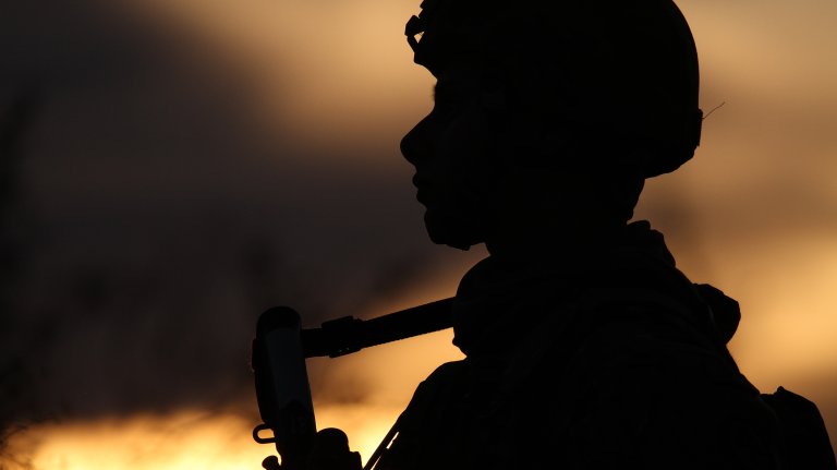 The crisp silhouette of a 2-113th Infantry Soldier is formed as the sun goes down marking the beginning of the night shift at Camp McGregor, New Mexico. (New Jersey National Guard photo by Spc Jacqueline Robinson)