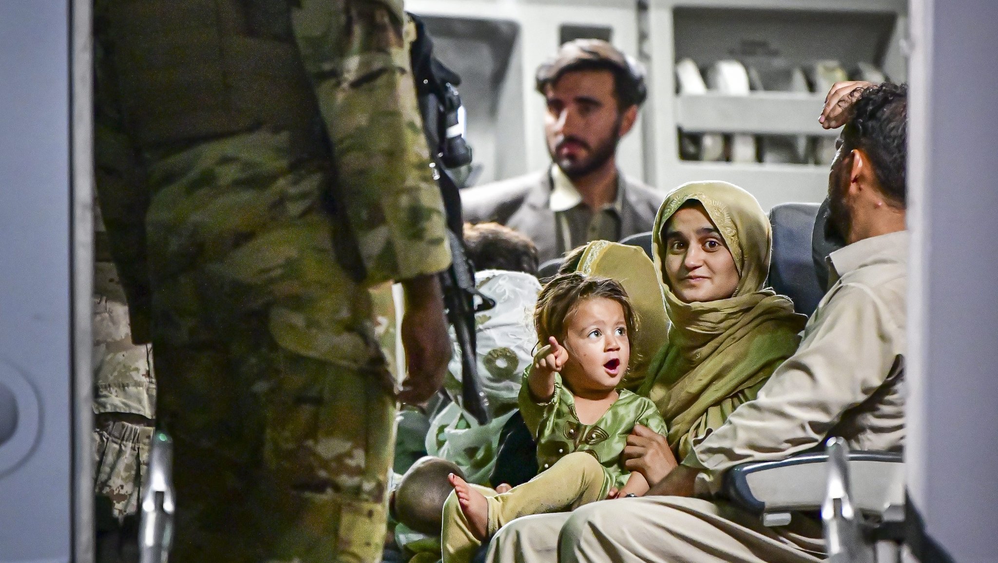 NAVAL AIR STATION SIGONELLA, Italy (Aug. 22, 2021) An Afghan family waits to exit a U.S. Air Force Boeing C-17 Globemaster III at Naval Air Station (NAS) Sigonella during Operation Allies Refuge Aug. 22, 2021. NAS Sigonella is currently supporting the Department of Defense mission to facilitate the safe departure and relocation of U.S. citizens, Special Immigration Visa recipients, and vulnerable Afghan populations from Afghanistan. (U.S. Navy photo by Mass Communication Specialist 1st Class Daniel M. Young)