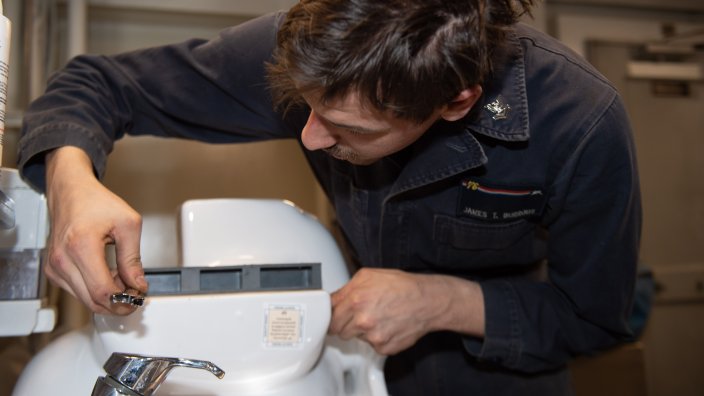 YOKOSUKA, Japan (Jan. 30, 2024) Hull Maintenance Technician 2nd Class James Burrous, from Richmond, Texas, assembles a toilet for replacement aboard the U.S. Navy’s only forward-deployed aircraft carrier, USS Ronald Reagan (CVN 76), while in-port Commander, Fleet Activities Yokosuka, Jan. 30. Ronald Reagan, the flagship of Carrier Strike Group 5, provides a combat-ready force that protects and defends the United States, and supports alliances, partnerships and collective maritime interests in the Indo-Pacific region. (U.S. Navy photo by Mass Communication Specialist 3rd Kyree Rogers)