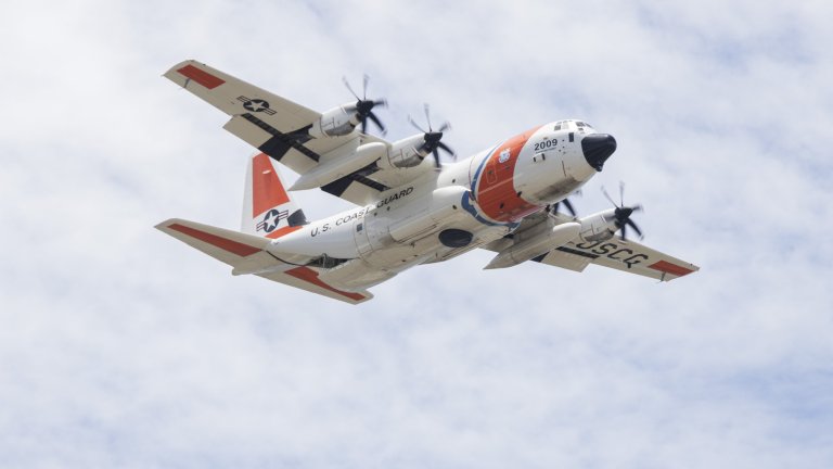 A U.S. Coast Guard C-130 Hercules with USCG Base Honolulu, performs aerial maneuvers while performing a Search and Rescue demonstration during the 2025 Kaneohe Bay Air Show at Marine Corps Base Hawaii, Aug. 10, 2025. The Kaneohe Bay Air Show provides an opportunity to showcase the aircraft, equipment and capabilities of the armed forces in the Indo-Pacific region to the local community. The air show contained aerial performances, static displays, demonstrations and vendors, was designed to celebrate MCBH’s longstanding relationship with the local community. (U.S. Marine Corps photo by Cpl. Jade K. Venegas)