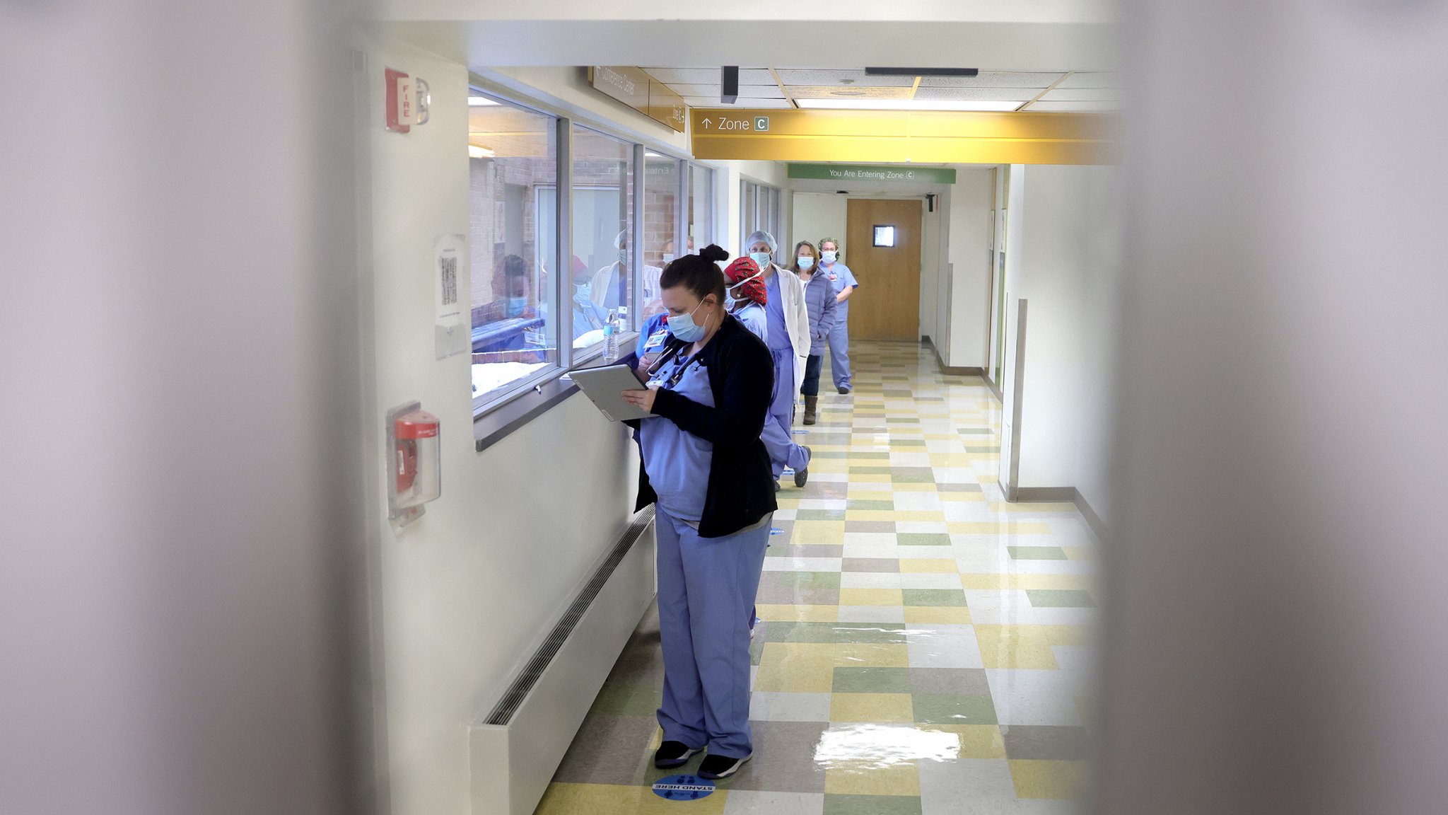 Frontline medical workers wait in line to receive the Pfizer vaccine for COVID-19 at the Virginia Hospital Center on December 16, 2020 in Arlington, Virginia. More than 1,950 of the hospital’s employees will be vaccinated over the next 4 days as the COVID-19 vaccine begins widespread distribution in the United States this week. (Photo by Win McNamee/Getty Images)