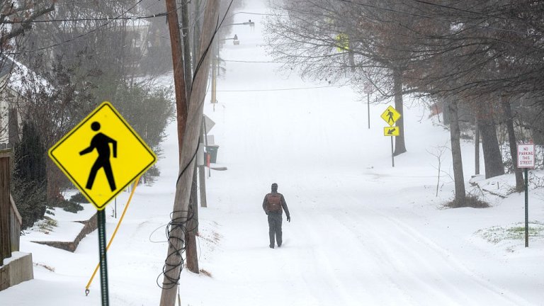 LITTLE ROCK, ARKANSAS - JANUARY 24: A person walks in the snow on January 24, 2026 in Little Rock, Arkansas. A massive winter storm is bringing frigid temperatures, ice, and snow to nearly 200 million Americans. (Photo by Will Newton/Getty Images)