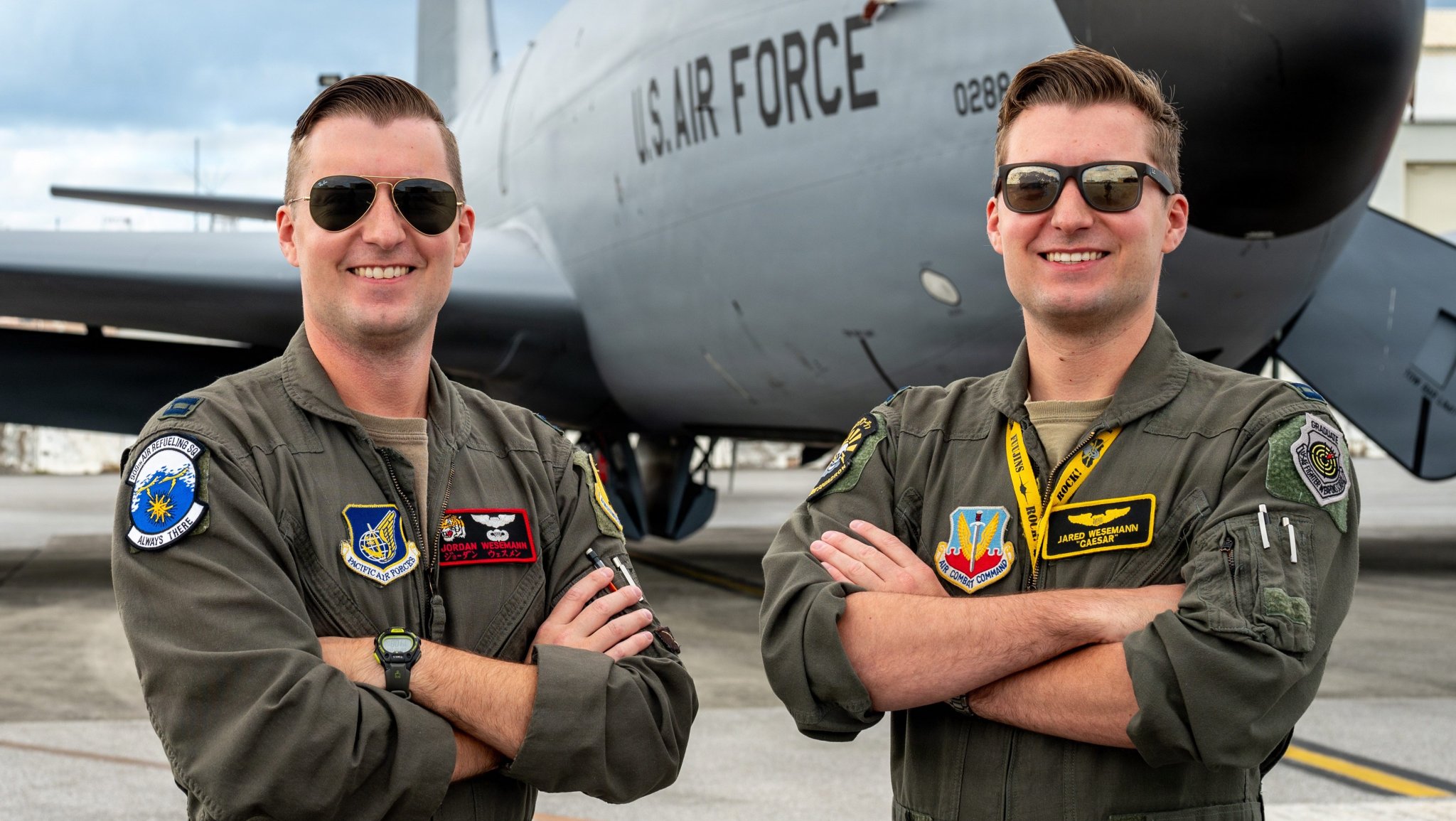 U.S. Air Force Capt. Jordan Wesemann, left, 909th Air Refueling Squadron instructor pilot, and Capt. Jared Wesemann, 4th Expeditionary Fighter Squadron pilot, deployed to Kadena Air Base, pose for a photo at Kadena AB, Japan, Dec. 4, 2025. The twin brothers shared the same sky and mission during Jordan Wesemann’s final flight at Kadena, a rare opportunity that united tanker and fighter aircrews over the Indo-Pacific. (U.S. Air Force photo by Senior Airman Melany Bermudez)