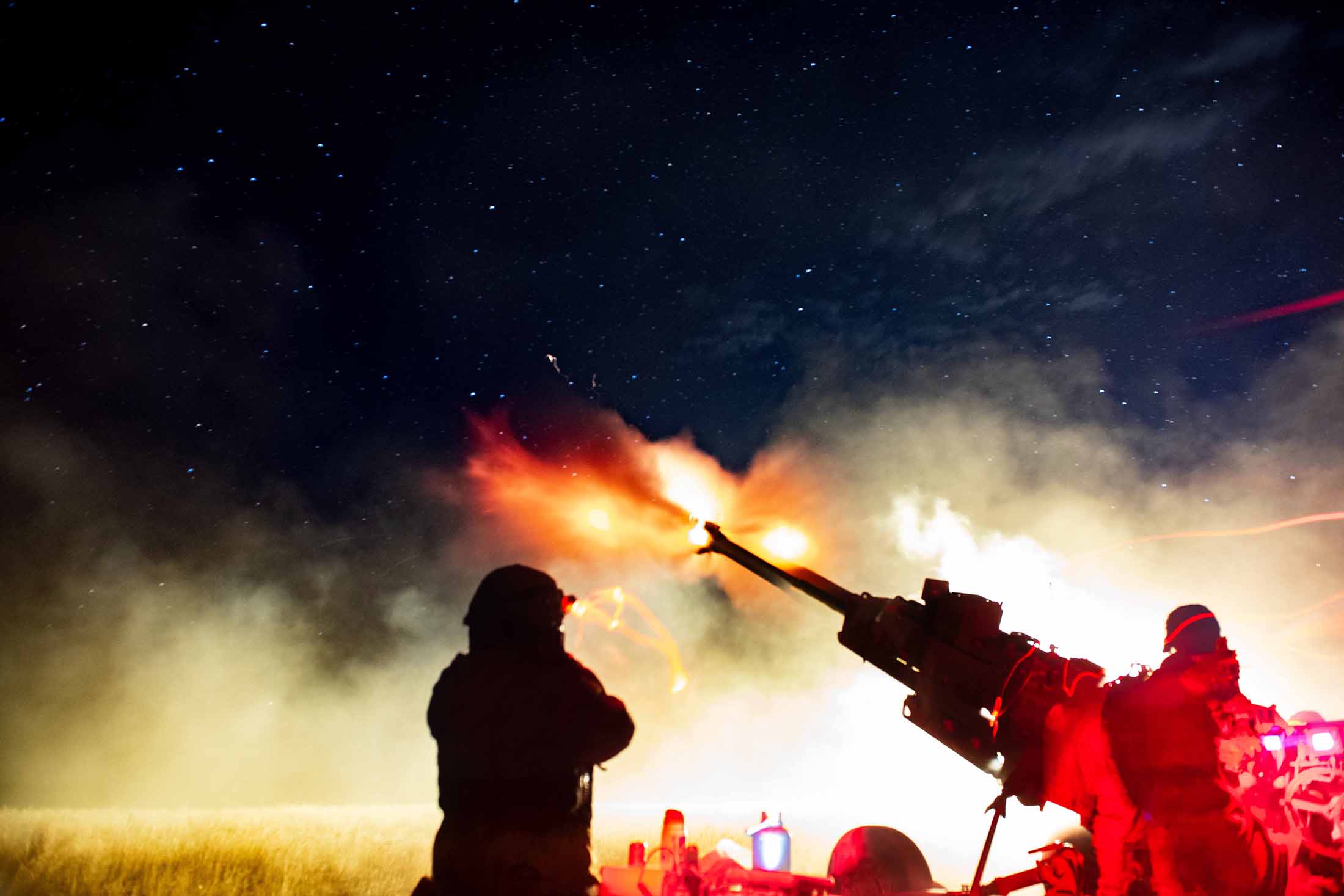 U.S. Army cannon crew members with 2nd Battalion, 146th Field Artillery Regiment, 81st Stryker Brigade Combat Team, Washington National Guard, assigned to Gun 6, conduct a night live-fire range a to certify crews on indirect fire missions using an M777 towed 155mm howitzer at Yakima Training Center, Wash., July 22, 2025. The night live-fire range was one of the culminating events of Raven Focus, a two-week collective training event hosted by the 81st SBCT. (U.S. Army National Guard photo by Spc. Tristin Salisbury)