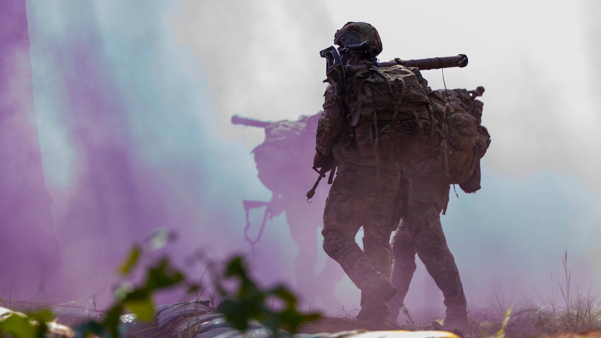 A Paratrooper assigned to 1st Battalion, 325th Airborne Infantry Regiment “Red Falcons”, 2nd Brigade Combat Team, 82nd Airborne Division, runs with his squad through an M18 smoke grenade during the 1st Sgt. Funk Deployment Readiness Exercise (DRE) at Fort Bragg, North Carolina, Sept. 9, 2025. The 1st Sgt. Funk DRE is a battalion-level readiness assessment for select units to evaluate systems and gauge the readiness efficiency of a unit’s ability to mobilize, prepare, and engage the enemy as the United States Immediate Response Force. (U.S. Army photo by Sgt. Aiden O’Marra)