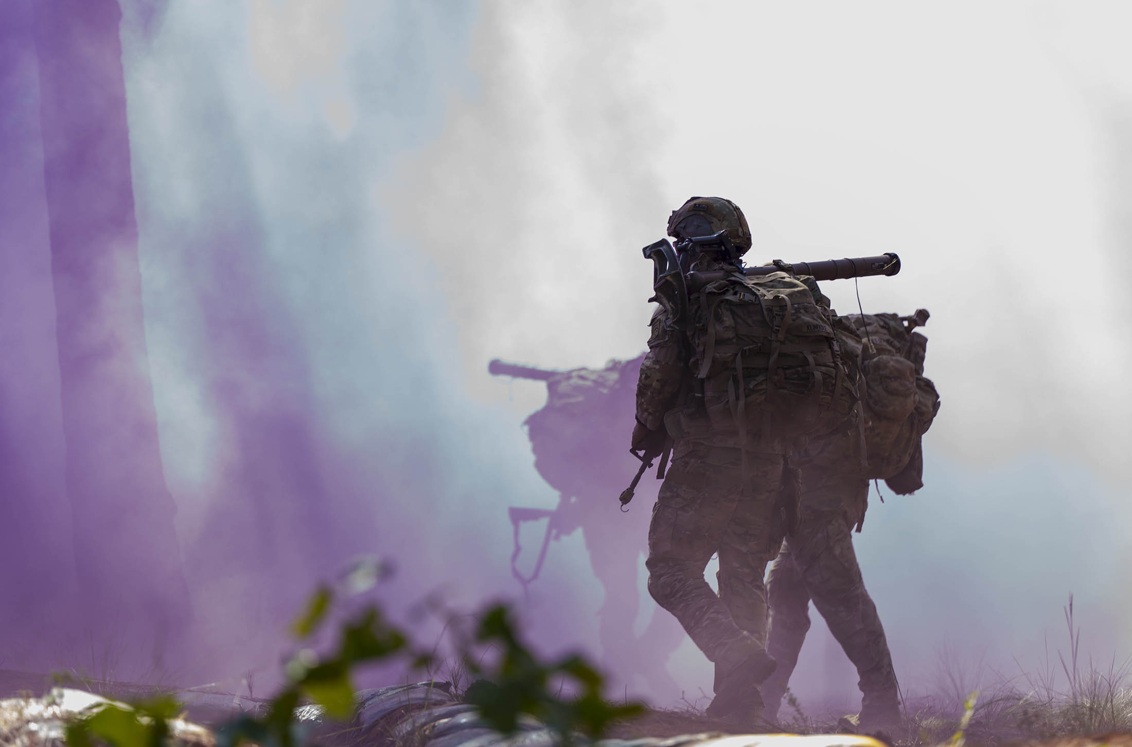 A Paratrooper assigned to 1st Battalion, 325th Airborne Infantry Regiment “Red Falcons”, 2nd Brigade Combat Team, 82nd Airborne Division, runs with his squad through an M18 smoke grenade during the 1st Sgt. Funk Deployment Readiness Exercise (DRE) at Fort Bragg, North Carolina, Sept. 9, 2025. The 1st Sgt. Funk DRE is a battalion-level readiness assessment for select units to evaluate systems and gauge the readiness efficiency of a unit’s ability to mobilize, prepare, and engage the enemy as the United States Immediate Response Force. (U.S. Army photo by Sgt. Aiden O’Marra)