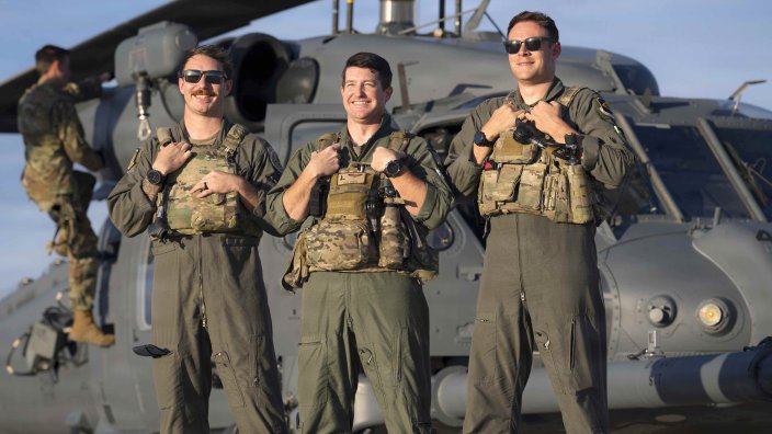 Lt. Col. Jeff Budis, center, Air Forces Southern operations directorate, chief of exercises and airshows, Capt. Nate Delaney, right, 55th Rescue Squadron chief of plans and exercises and Staff Sgt. James Delaura, left, special missions aviator with the 563rd Operations Support Squadron pose for a photo in front of an HH-60W Jolly Green II at Davis-Monthan Air Force Base, Arizona, after returning from a successful rescue mission, Feb. 6, 2026. The mission demonstrated the Air Force rescue community’s ability to rapidly integrate qualified personnel across multiple units to respond when time, distance and personnel availability converge. (U.S. Air Force photo by Tech. Sgt. Rachel Maxwell)