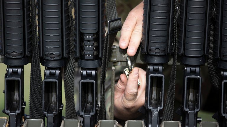 A U.S. Army Reserve cadre member representing the United States Army Reserve Command, locks a weapons rack for the three-gun transition range event with the M26 shotgun, M4 carbine, and the M17 pistol during the 2020 U.S. Army Reserve Best Warrior Competition at Fort McCoy, Wisconsin, Sept. 7. More than 40 Soldiers from across the nation traveled to compete in this year’s Best Warrior, hosted from Sept. 4-10, 2020. The 2020 BWC is an annual competition that brings in the best Soldiers across the U.S. Army Reserve to earn the title of “Best Warrior” among their peers. Competitors are evaluated on their individual ability to adapt and overcome challenging scenarios and battle-focused events, which test their technical and tactical abilities under stress and extreme fatigue. (U.S. Army Reserve photo by Pfc. Tierra Sims)