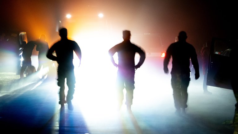 Task Force Pegasus Troopers stand silhouetted before attempting to complete the Norwegian Foot March on Forward Operating Site Powidz, Poland, Aug. 8, 2024. Task Force Pegasus has joined with Allied Nation Soldiers and local community members to attempt the 18.6-mile march. The march was first held in 1915 as a test of marching endurance for soldiers in the Norwegian Army. The goal today is to stimulate the general interest of marching over extended distances amongst military and civilian personnel. (U.S. Army photo by Pfc. Julian Winston)