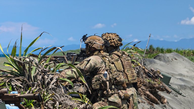 Image: Two U.S. Army Soldiers assigned to the 1st Battalion, 21st Infantry Regiment, 2nd Mobile Brigade Combat Team, 25th Infantry Division, hold a security posture on the firing line with a M249 Machine Gun in a Counter Landing live-fire exercise, in support of Exercise Balikatan 25, at Aparri, Cagayan Valley, Philippines, May 3, 2025. This exercise enhanced combined readiness by training U.S. and Philippine forces to counter a simulated adversary assault on key maritime terrain. Balikatan is a longstanding annual exercise between the Armed Forces of the Philippines and U.S. military designed to strengthen our ironclad alliance, improve our capable combined force, and demonstrate our commitment to regional security and stability. (U.S. Army photo by Staff Sgt. Brenden Delgado) 