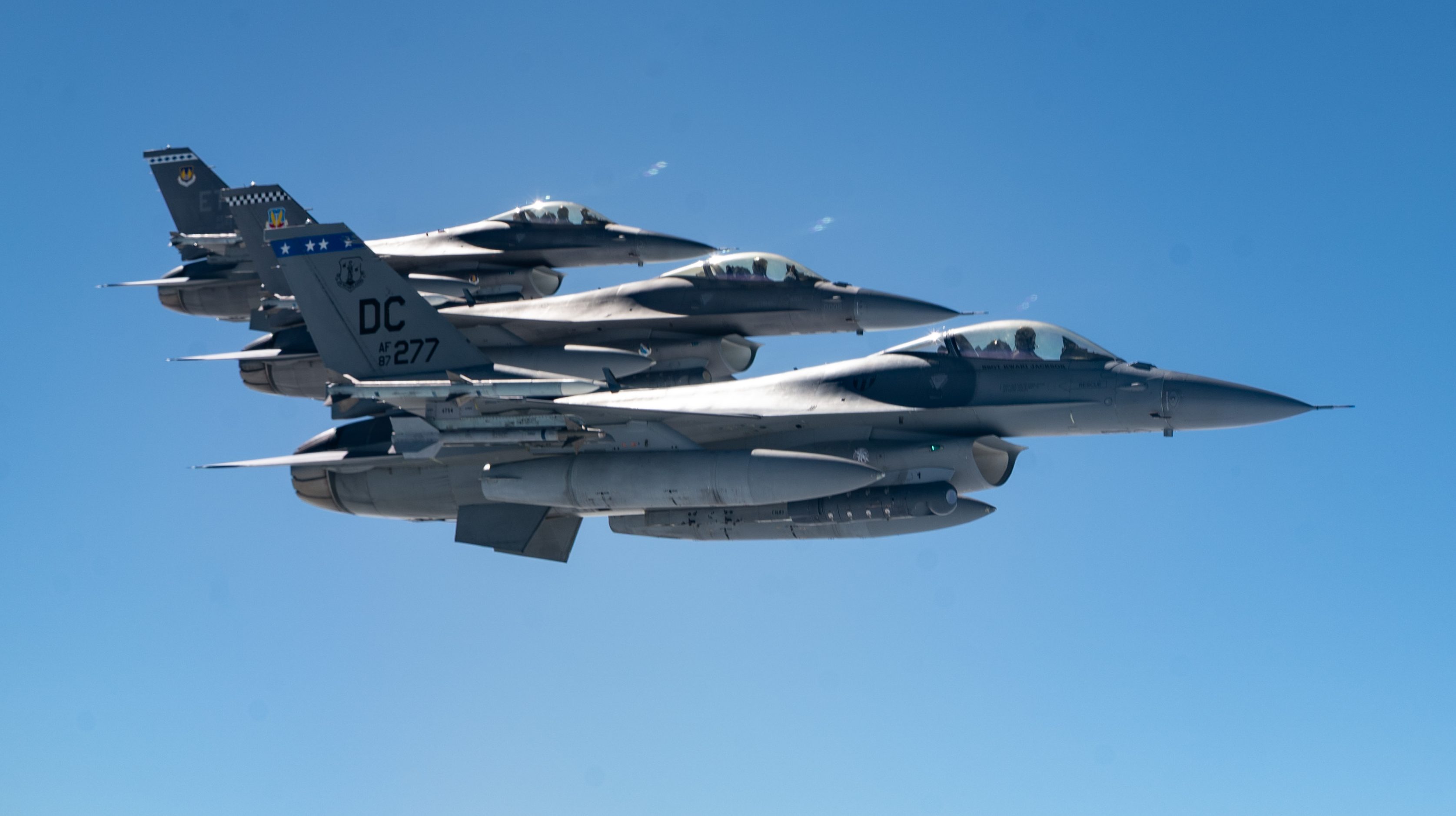 F-16 Fighting Falcons assigned to the 113th Fighter Wing, District of Columbia Air National Guard, Joint Base Andrews, Maryland; the 85th Test and Evaluation Squadron, Eglin Air Force Base, Florida; and the 96th Test Wing, Eglin AFB, Florida, fly off the wing of a KC-46A Pegasus operated by aircrew assigned to the 22nd Air Refueling Wing, McConnell Air Force Base, Kansas, during Exercise Bamboo Eagle 25-3, off the coast of California, Aug. 7, 2025. Bamboo Eagle 25-3 is a joint military training exercise involving service members from the U.S. Department of Defense operating, maintaining, commanding and controlling and supporting more than 100 aircraft at over 15 locations. (U.S. Air Force photo by Staff Sgt. Tryphena Mayhugh)