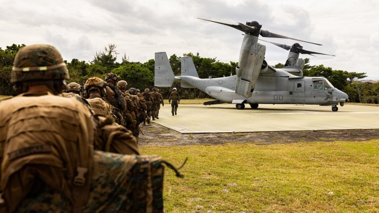 U.S. Marines with 2nd Battalion, 7th Marines, forward deployed to 3rd Marine Division, 4th Marine Regiment as part of the unit deployment program, load onto an MV-22 Osprey while conducting a helicopter raid as part of a combined Marine Corps Combat Readiness Evaluation on Camp Schwab, Okinawa, Japan, Jan. 27, 2026. The MCCRE is a formal evaluation of 4th Marine Regiment, 3d Reconnaissance Battalion, and 3rd Marine Division's Headquarters Battalion to confirm combat readiness for each unit. (U.S. Marine Corps Photo by Cpl. John Simpson)
