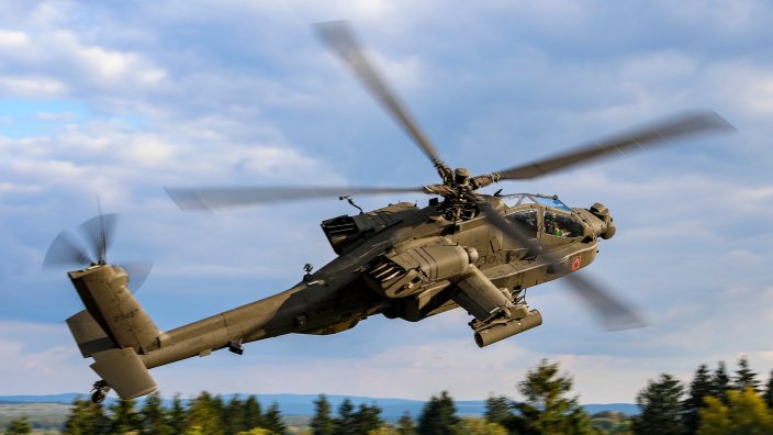 An AH-64E Apache crew, assigned to 1-3 Attack Battalion, 12th Combat Aviation Brigade, prepares to engage during aerial gunnery training at Grafenwoehr Training Area, Germany, Oct. 2, 2025. Gunnery qualifications are a cornerstone of their ability to provide a lethal and credible aviation force to U.S. Army Europe and Africa, essential for maintaining the combat readiness and lethality of 1-3 Attack Battalion. (U.S. Army photo by Spc. Josefina Garcia)
