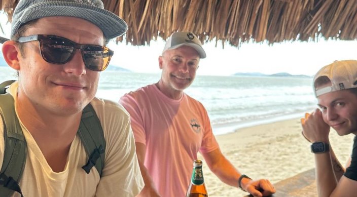 Jeff Evans, center, with his sons Jake and Austin, at a seaside bar in Nha Trang, where his father was station in 1968. Family members believe the brothers might have gotten together in the city before David Evans' death in November 1968.
