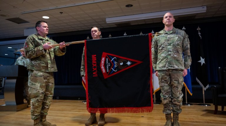 Image: COLORADO SPRINGS, Colo. - Chief Master Sgt. Seth Hogan, command senior enlisted leader Space Forces Northern unfurls the SPACEFOR-NORTH guidon during the SPACEFOR-NORTH activation ceremony at Peterson Space Force Base, Colo., Jan 30, 2026. U.S. Space Forces Northern, serves as the Space Force service component to U.S. Northern Command. (U.S. Space Force photo by John Ayre)