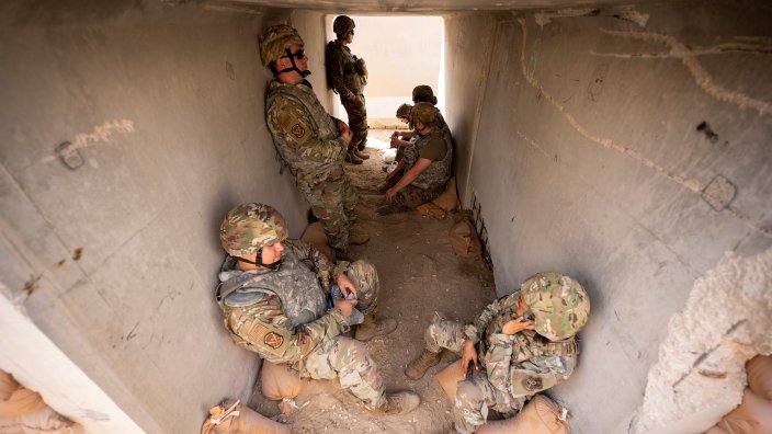 U.S. Air Force Airmen assigned to the 379th Air Expeditionary Wing take cover in a bunker during exercise Grand Shield 22-2 at Al Udeid Air Base, Qatar, Dec. 15, 2021. Grand Shield tested Al Udeid’s readiness to respond to regional threats. (U.S. Air Force photo by Senior Airman Noah D. Coger)