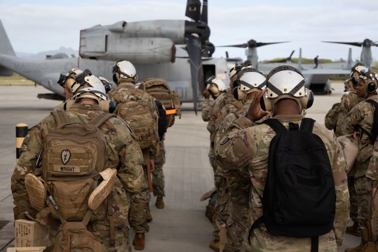 U.S. Army Soldiers with the 25th Infantry Division prepare to embark an MV22B Osprey attached to Marine Medium Tiltrotor Squadron 268, 1st Marine Aircraft Wing, at Marine Corps Air Station Kaneohe Bay, Marine Corps Base Hawaii, Jan. 12, 2023. VMM-268 provided transport for troops and supplies to Pōhakuloa Training Area on Hilo, Hawaii. (U.S. Marine Corps photo by Cpl. Chandler Stacy)