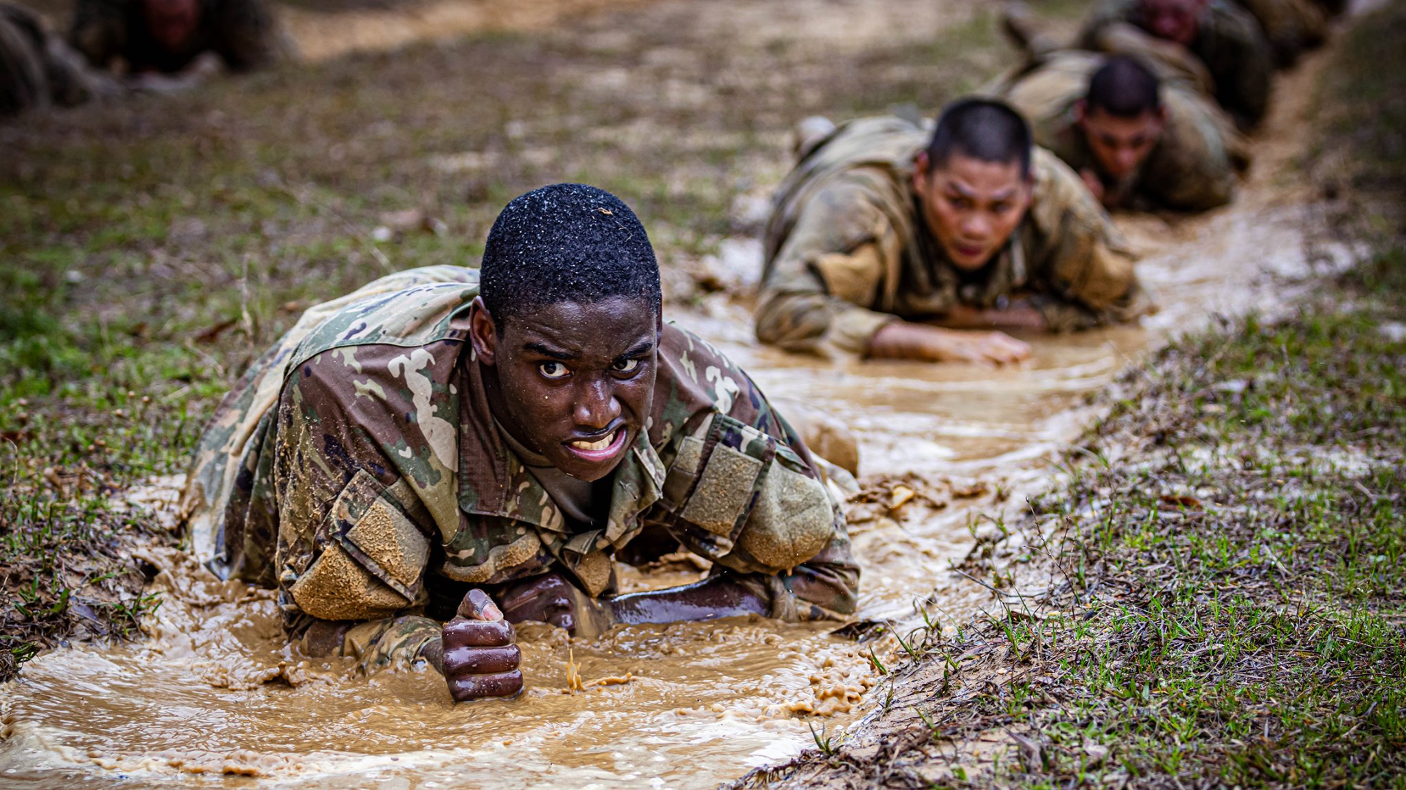 A trainee from C Company, 2nd Battalion, 58th Infantry Regiment, 198th Infantry Brigade low crawls through an obstacle the Sand Hill Obstacle Course March 4, 2024 on Sand Hill. (U.S. Army photo by Capt. Stephanie Snyder)