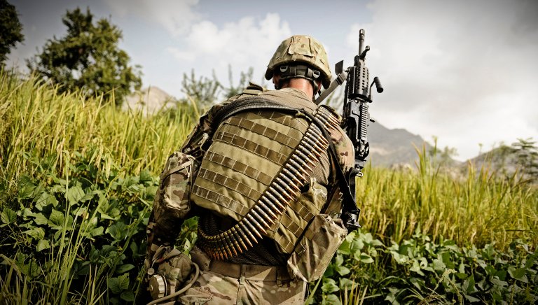 U.S. Army Spc. Jake Amato, an MK48 machine gunner assigned to Laghman Provincial Reconstruction Team, patrols through a field looking for triggermen in the Alisheng district, Laghman province, Afghanistan, on Sept. 12, 2011. (DoD photo by Staff Sgt. Ryan Crane, U.S. Army. )