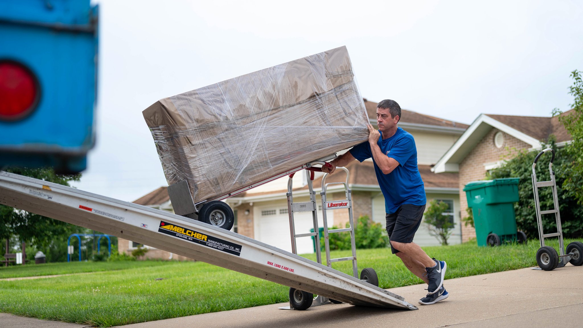 A mover loads boxes into the truck for transport to the next duty station during a Permanent Change of Station on Scott Air Force Base, Illinois, July 18, 2025. The Department of Defense established the Permanent Change of Station Joint Task Force to improve the moving experience for military members and their families. (U.S. Air Force photo by Staff Sgt. Stephanie Henry)