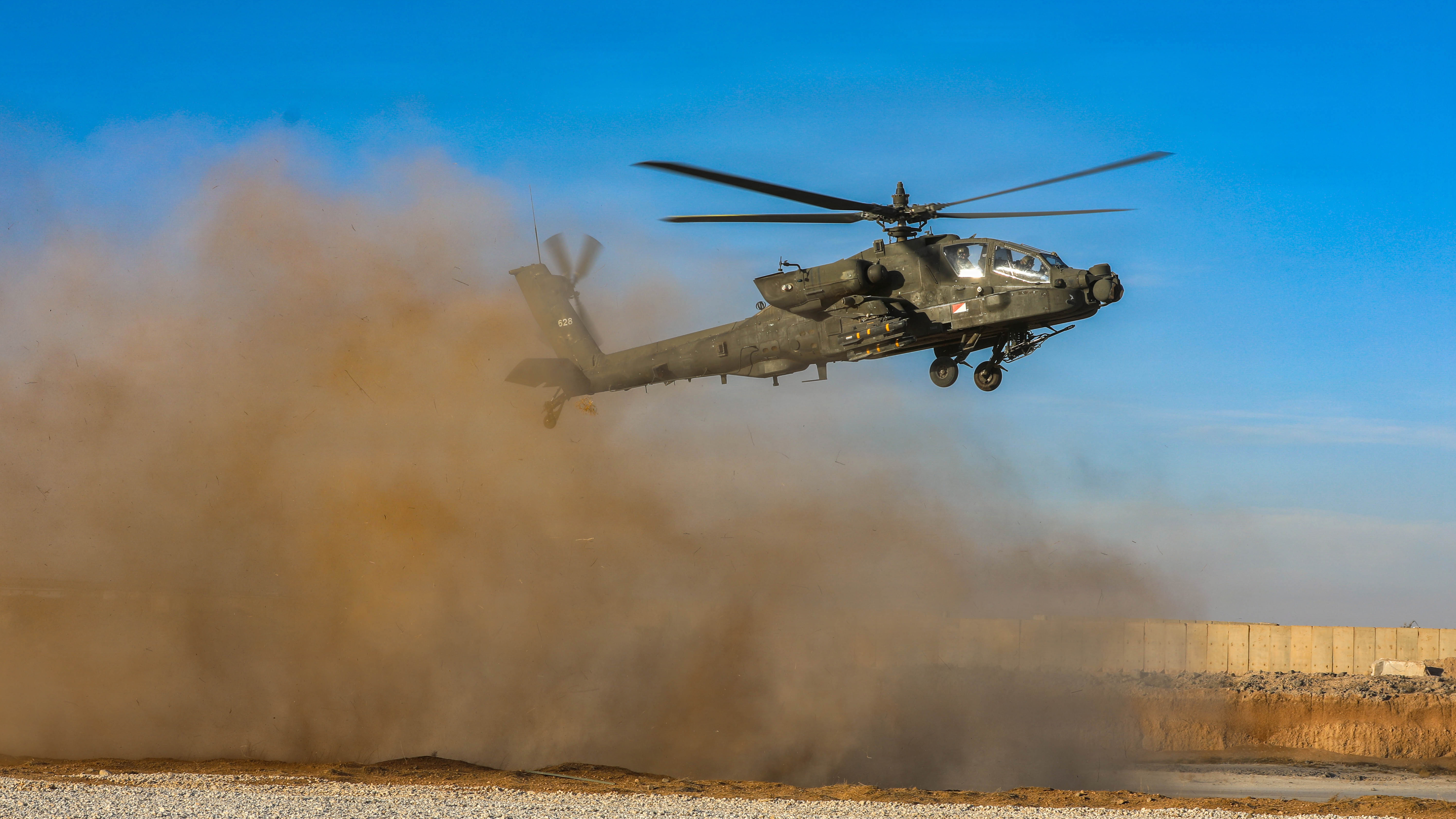 An AH-64 Apache helicopter assigned to Task Force Nighthawk flies through a landing zone during aviation operations in the U.S. Central Command area of responsibility on Nov. 3, 2025. Routine flight operations ensure aircrews remain mission-ready while supporting ongoing operational requirements throughout the theater. (U.S. Army photo by Spc. Doniel Kennedy.)