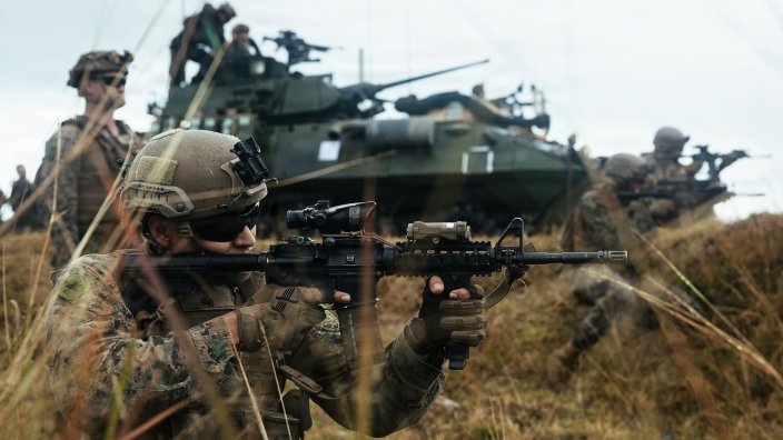 U.S. Marine Corps Lance Cpl. Adrian Ibarra, a rifleman with Weapons Company, Battalion Landing Team 3rd Battalion, 1st Marine Regiment, 31st Marine Expeditionary Unit, fires an M4 carbine during an integrated section attack range at Camp Schwab, Okinawa, Japan, Jan. 31, 2026. The training integrated Light Armored Reconnaissance and Combined Anti-Armor Team vehicle-mounted fires with dismounted maneuver, enhancing the BLT’s ability to execute surface standing missions and tactical recovery of aircraft personnel. The 31st MEU is a persistent, combat credible force operating aboard the ships of the Tripoli Amphibious Ready Group in the U.S. 7th Fleet area of operations, routinely interacting and operating with our allies and partners to contribute to deterrence, security, crisis response, and combat operations in the Indo-Pacific region. Ibarra is a native of California. (U.S. Marine Corps photo by Sgt. Alora Finigan)
