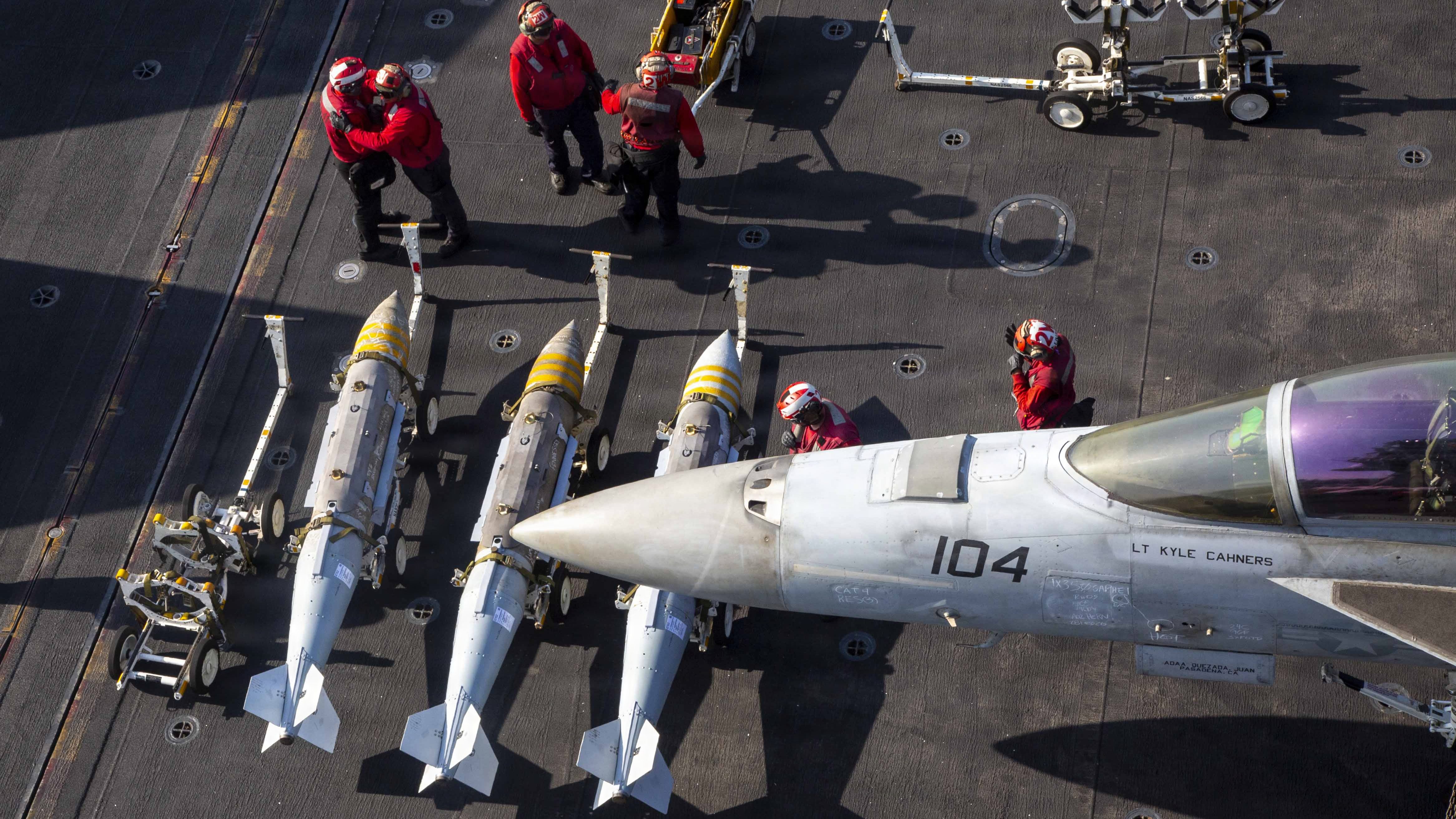 U.S. Sailors prepare to load ordnance onto an F/A-18F Super Hornet, attached to Strike Fighter Squadron (VFA) 41, on the flight deck of Nimitz-class aircraft carrier USS Abraham Lincoln (CVN 72) in support of Operation Epic Fury, Feb. 28, 2026. (U.S. Navy photo)