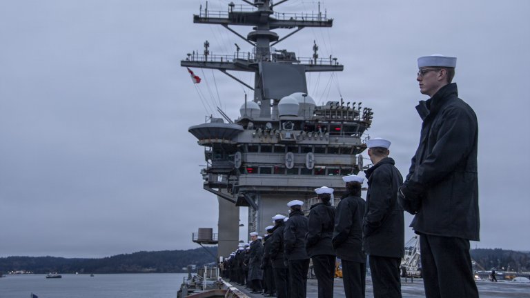 Image: U.S. Sailors man the rails on the flight deck of Nimitz-class aircraft carrier USS Nimitz (CVN 68) during the ship's final departure from Naval Base Kitsap-Bremerton, Mar. 7, 2026. Nimitz is underway in the U.S. 3rd Fleet area of operations as part of a scheduled homeport shift to Norfolk, VA. (U.S. Navy photo by Mass Communication Specialist 2nd Class Peter K. McHaddad) 