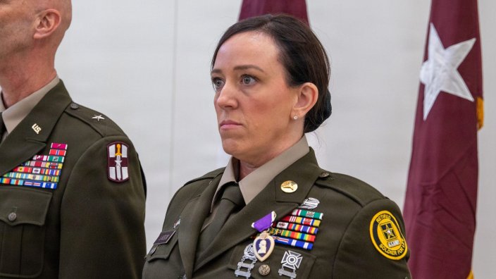 Brig. Gen. Todd Traver, deputy commanding general of the 807th Theater Medical Command, presents the Purple Heart to retired U.S. Army Reserve Sgt. 1st Class Christina Larson during her retirement ceremony at Fort Sheridan, Illinois, Feb. 20, 2026. Larson received the award for wounds sustained during a 2015 deployment to Afghanistan. (U.S. Army Reserve photo by Staff Sgt. Mikayla Fritz)