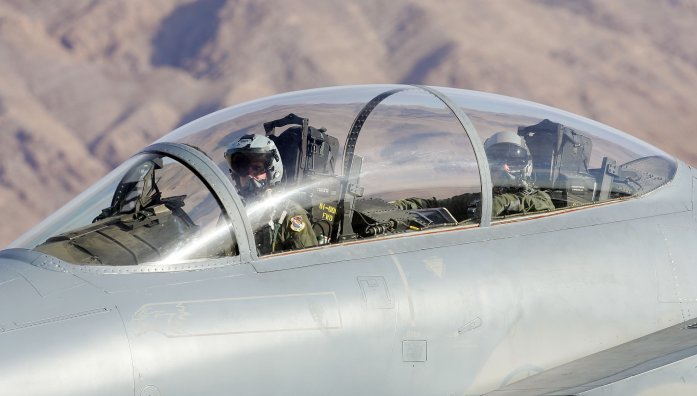 NELLIS AFB, NV - APRIL 25: A United States Air Force pilot (L) and weapons system officer look out the cockpit of their F-15E Strike Eagle as the jet is prepared for takeoff at Nellis Air Force Base while participating in the Joint Expeditionary Force Experiment 2006 (JEFX 06) April 25, 2006 in Las Vegas, Nevada. JEFX is a biannual test of new systems and technologies by every branch of the military in an attempt to speed their introduction into the modern battlefield. This year's tests involve about 1,400 personnel from the United States, Great Britain, Canada and Australia studying new technologies during mock combat over the Nevada desert and center on finding better ways to communicate critical information between armed forces. (Photo by Ethan Miller/Getty Images)
