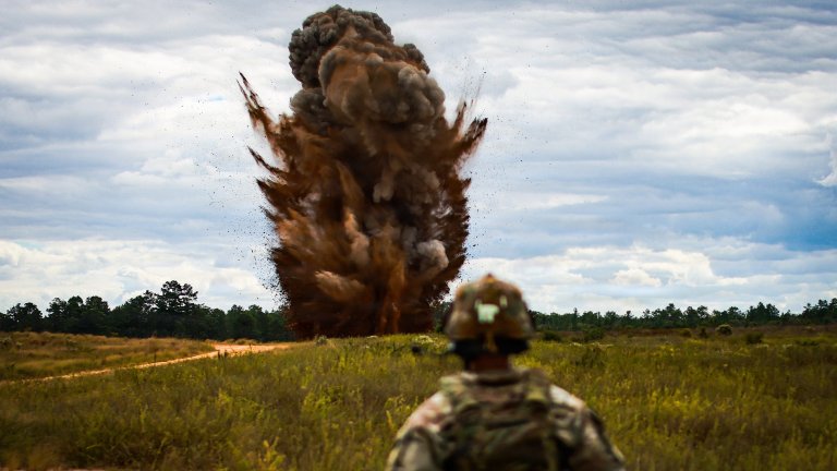 U.S. Soldier watches a 40-pound shaped charge detonation during Operation Tiger Dawn at Camp Mackall, N.C., Oct. 6, 2025. The controlled blast conducted under strict safety protocols helps engineers validate breaching techniques and sustain the XVIII Airborne Corps’ readiness to project decisive combat power. (U.S. Army photo by Sgt. Nolan Brewer)