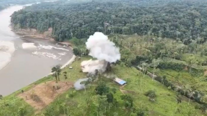 A plume of smoke rises from a destroy alleged drug smuggling building in Ecuador following U.S. strikes.