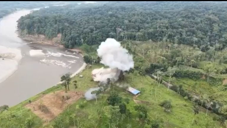 A plume of smoke rises from a destroy alleged drug smuggling building in Ecuador following U.S. strikes.