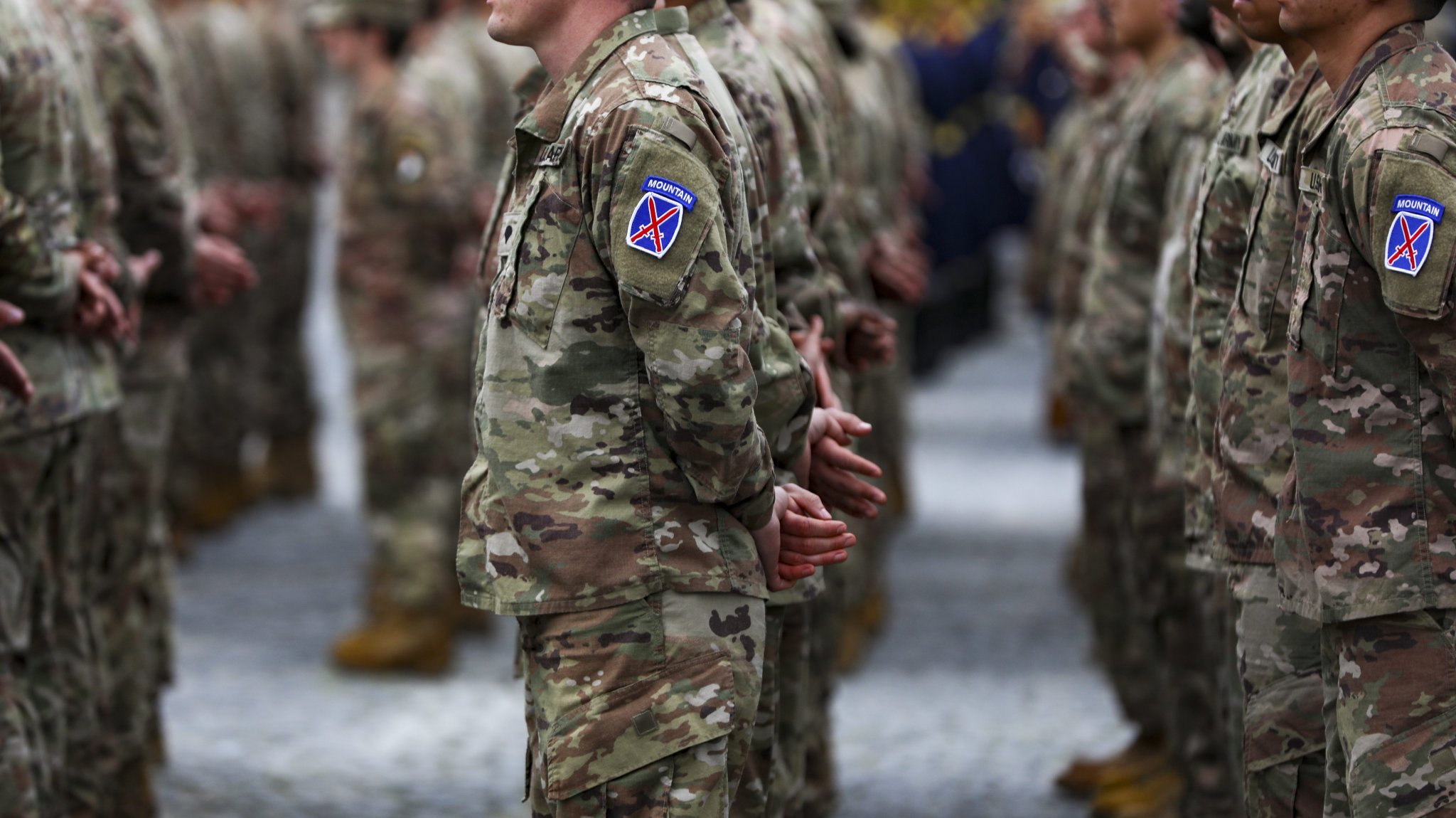 Soldiers of Headquarters and Headquarters Battalion, 10th Mountain Division stand in formation prior to marching during the pass and review for the Transfer of Authority Ceremony on April 5, 2023, at the Carol I National Defense University in downtown Bucharest. The 10th Mountain Division headquarters is deployed to Europe to support the mission, assure allies and partners, and deter further Russian aggression.