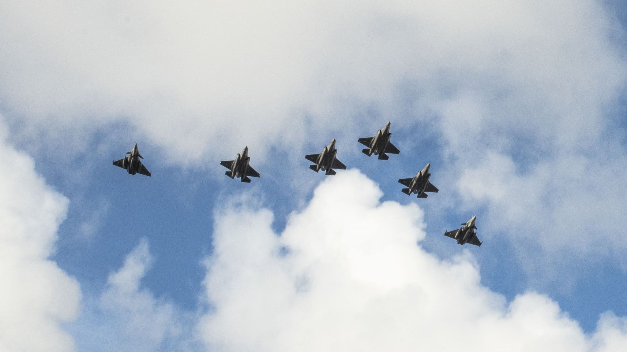 Four U.S. Air Force F-35A Lightning IIs from the 466th Fighter Squadron and two French Dassault Rafales fly over the Balau Games, Palau, July 9, 2023. The fighter jets, in Palau for Northern Edge 23-2, a Pacific Air Forces led multilateral, joint field training exercise, showed their commitment to the Indo-Pacific region by performing this movement at the closing game of the annual local olympic tournament in which all 13 states of Palau participate. (U.S. Air Force photo by 1st Lt. Michelle Chang)